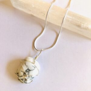 White Howlite wire wrapped crystal on a silver plated necklace.