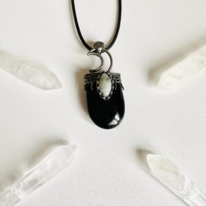 Black onyx necklace with a crescent moon topper.