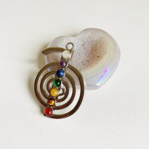 Silver plated reiki shaped pendant with chakra crystals.